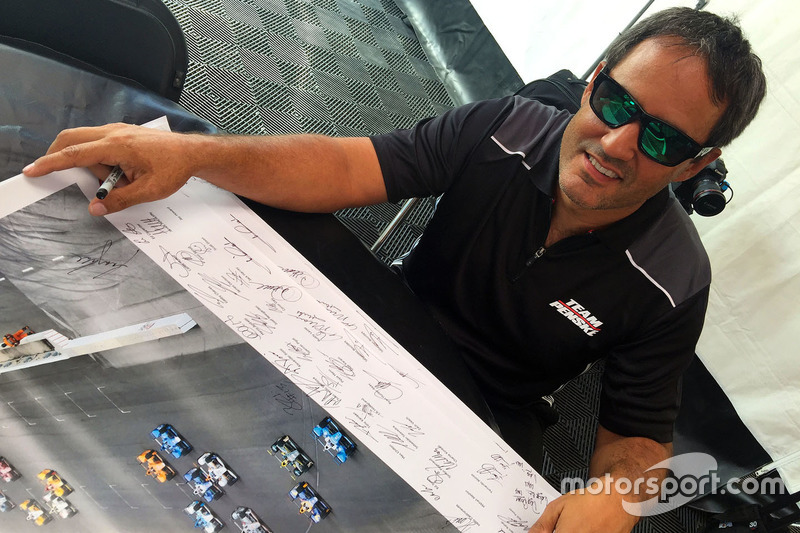 Juan Pablo Montoya signs Justin Wilson poster