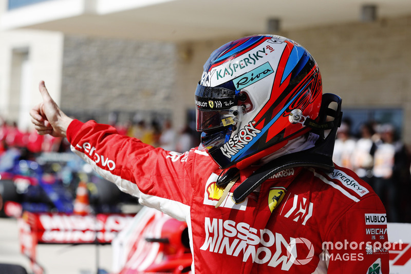 Kimi Raikkonen, Ferrari, gives a thumbs up as he celebrates after winning the race