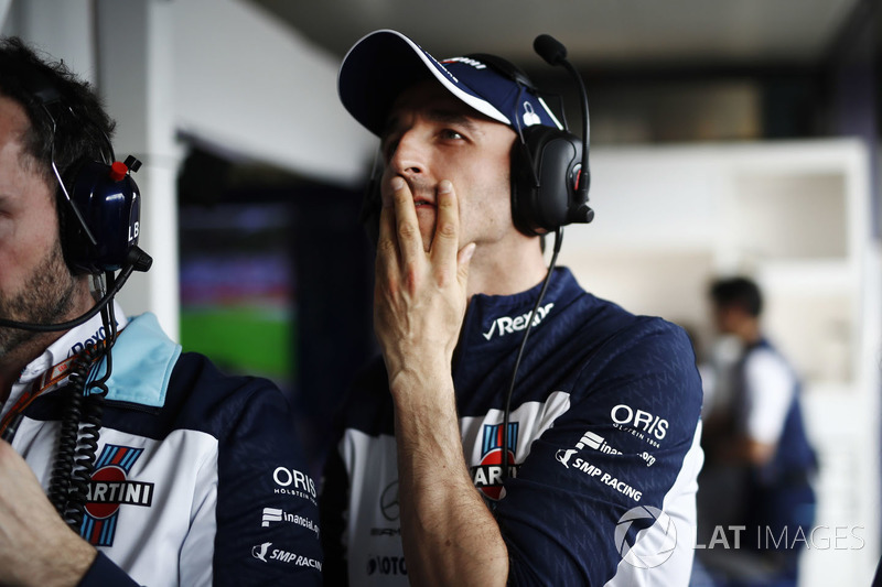 Robert Kubica, Williams Martini Racing, watches qualifying in the team's garage