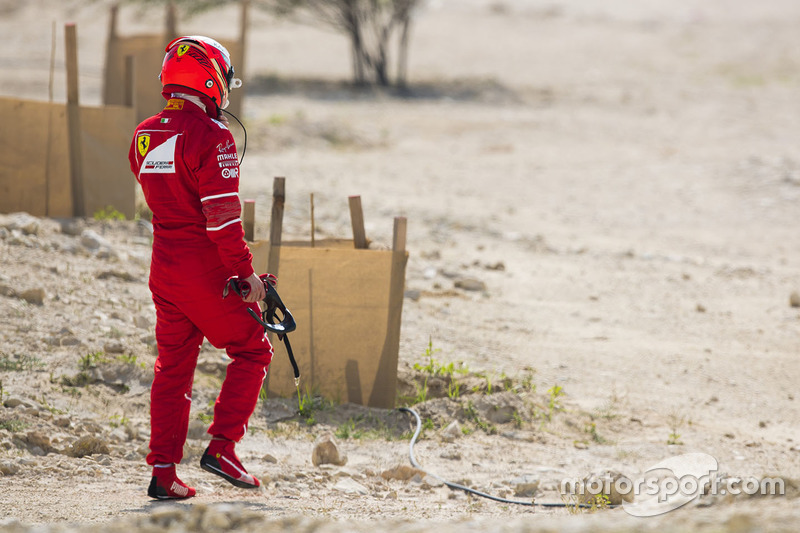 Kimi Raikkonen, Ferrari, walks back to his garage