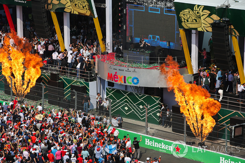 DJ Hardwell plays from the podium after the driver celebrations with flame throwers either side