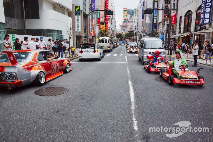 Daniel Ricciardo y Max Verstappen, Red Bull Racing conducen alrededor de Tokio en un coche de Bosozuko