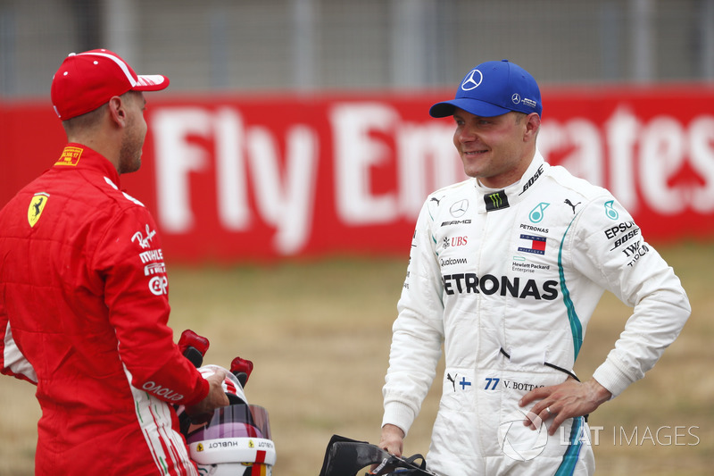 Pole sitter Sebastian Vettel, Ferrari, talks to Valtteri Bottas, Mercedes AMG F1