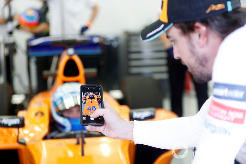 Jimmie Johnson in the McLaren, Fernando Alonso takes a photo  