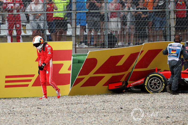 Sebastian Vettel, Ferrari SF71H walks in after crashing out of the race