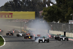 Lewis Hamilton, Mercedes AMG F1 W07 Hybrid locks a wheel under braking into turn one ahead of Max Ve