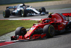 Kimi Raikkonen, Ferrari SF71H, leads Lewis Hamilton, Mercedes AMG F1 W09