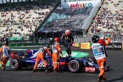 Marshals recover the car of Pierre Gasly, Scuderia Toro Rosso STR12 after stopping on track in FP3