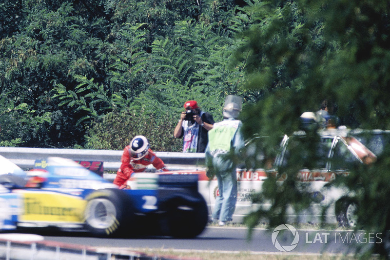 Taki Inoue, Arrows FA16 is knocked down by a medical car after trying to put out a fire