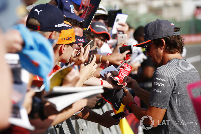 Fernando Alonso, McLaren, signs autographs for fans