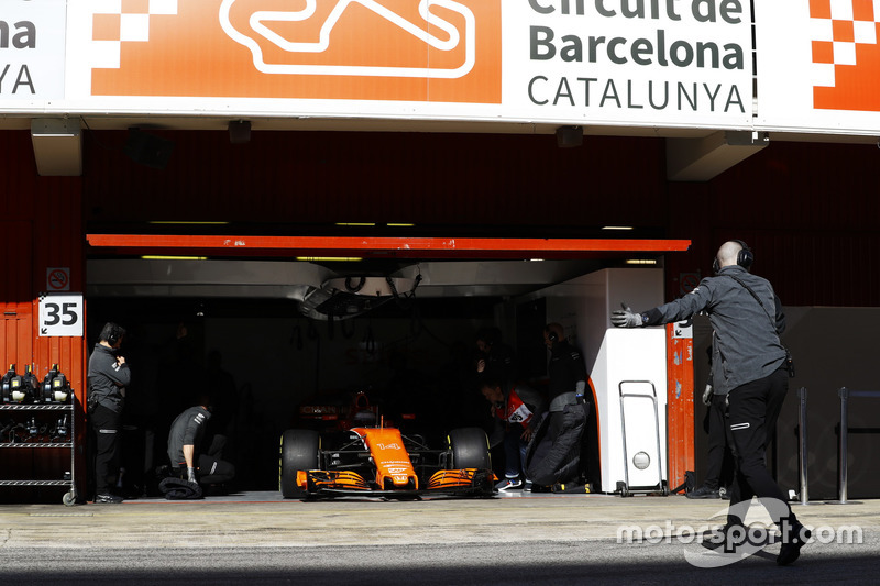 The McLaren garage door is raised as Fernando Alonso, McLaren MCL32 enters the pit lane