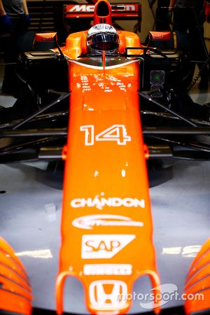 Fernando Alonso, McLaren, in cockpit, in garage, with helmet visor raised