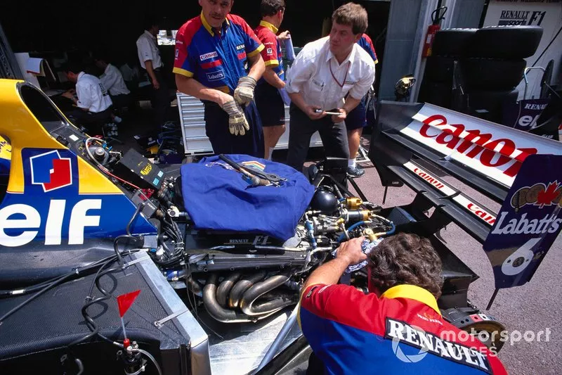 Mechanics work on a Williams FW14B Renault in the pits