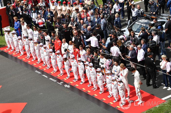 Los pilotos observan el himno nacional en la grilla