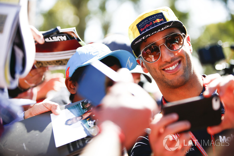 Daniel Ricciardo, Red Bull Racing, takes a photo of himself with a fan