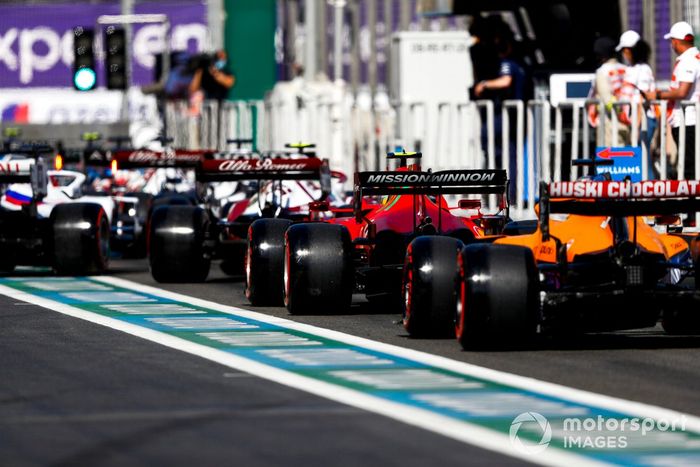 Carlos Sainz Jr., Ferrari SF21, Daniel Ricciardo, McLaren MCL35M, en fila para salir de pits