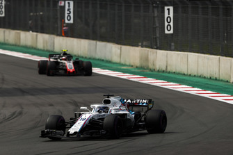 Lance Stroll, Williams FW41, leads Kevin Magnussen, Haas F1 Team VF-18