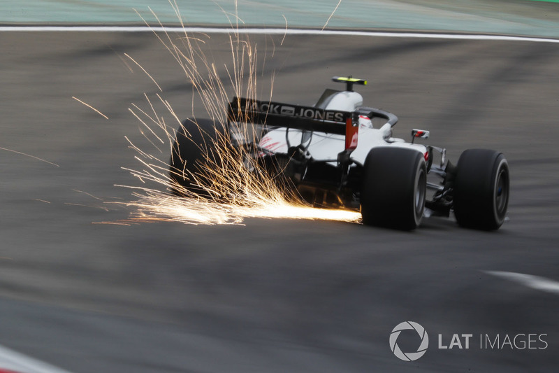 Sparks fly from the car of Kevin Magnussen, Haas F1 Team VF-18 Ferrari