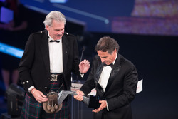 Nelson Piquet collects his Gregor Grant Award on stage with Gordon Murray