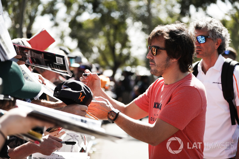 Fernando Alonso, McLaren, signs autographs for fans