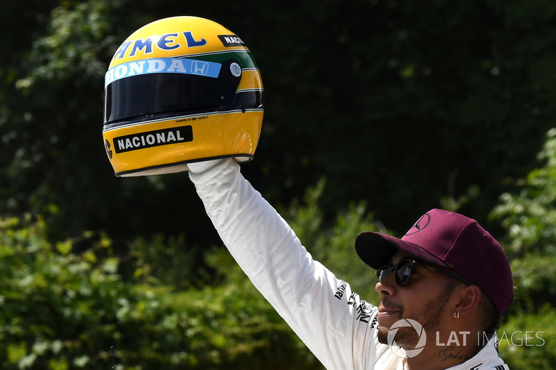 Pole sitter Lewis Hamilton, Mercedes AMG F1 celebrates in parc ferme, the helmet of Ayrton Senna