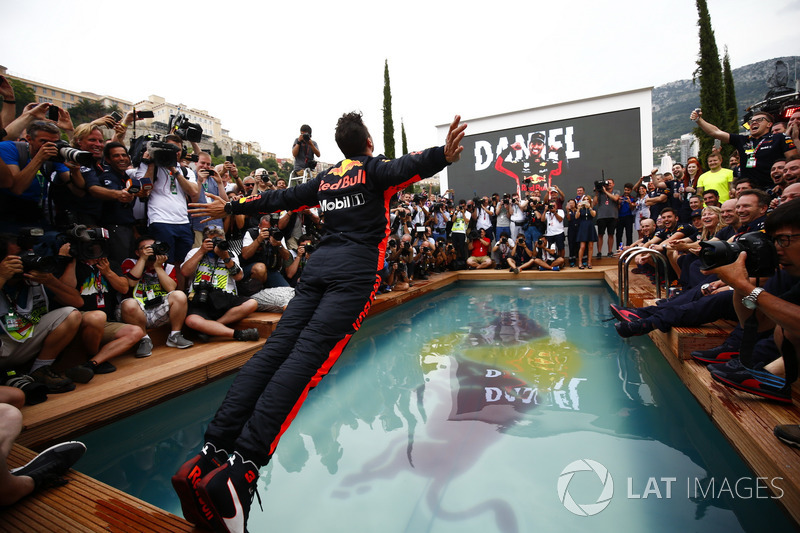 Daniel Ricciardo, Red Bull Racing, dives into the swimming pool on the Red Bull Energy Station