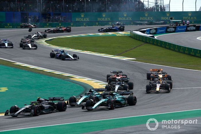 Lewis Hamilton, Mercedes F1 W14, Fernando Alonso, Aston Martin AMR23, Lance Stroll, Aston Martin AMR23, el resto de la parrilla en la salida mientras Alex Albon, Williams FW45, Kevin Magnussen, Haas VF-23, chocan al fondo.