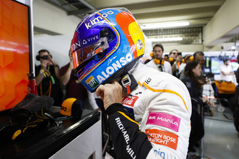 Fernando Alonso, McLaren, adjusts his crash helmet