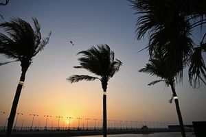 A helicopter flies over during sunset