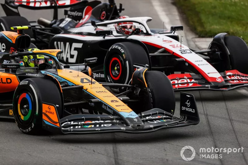 Lando Norris, McLaren MCL60, battles with Kevin Magnussen, Haas VF-23