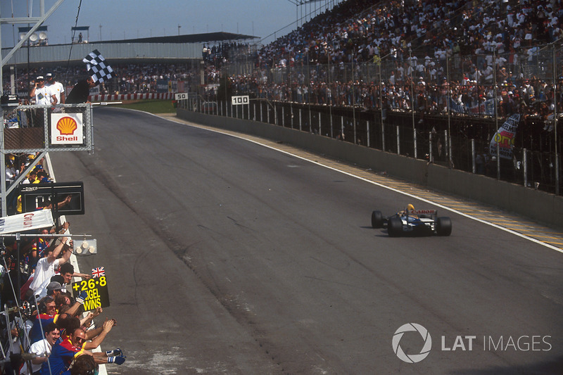 Nigel Mansell, Williams FW14B, takes the chequered flag