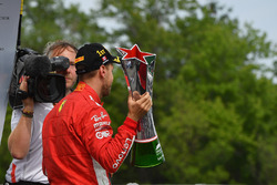 Race winner Sebastian Vettel, Ferrari celebrates on the podium with the trophy