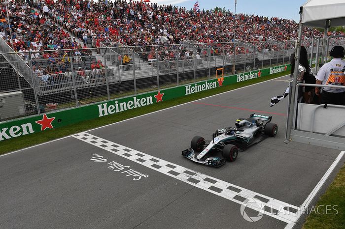 Valtteri Bottas, Mercedes-AMG F1 W09 llega a la bandera a cuadros ondeada por Winnnie Harlow 