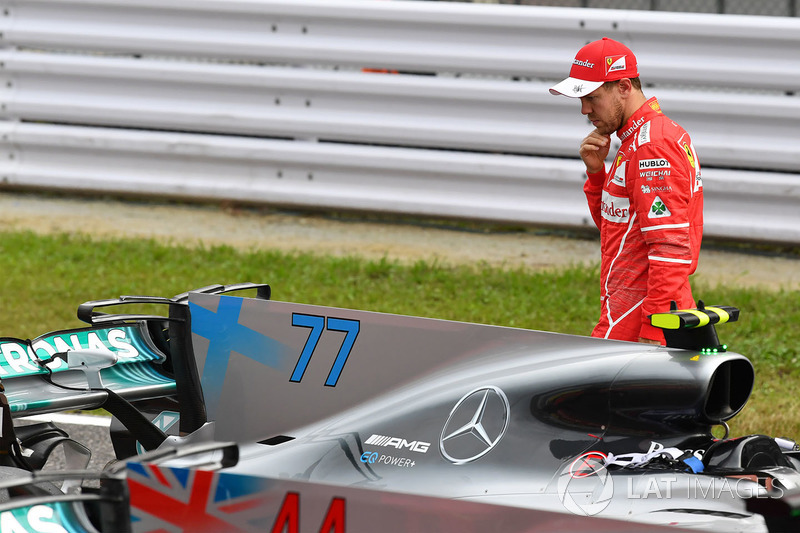 Sebastian Vettel, Ferrari looks at Mercedes-Benz F1 W08 in parc ferme