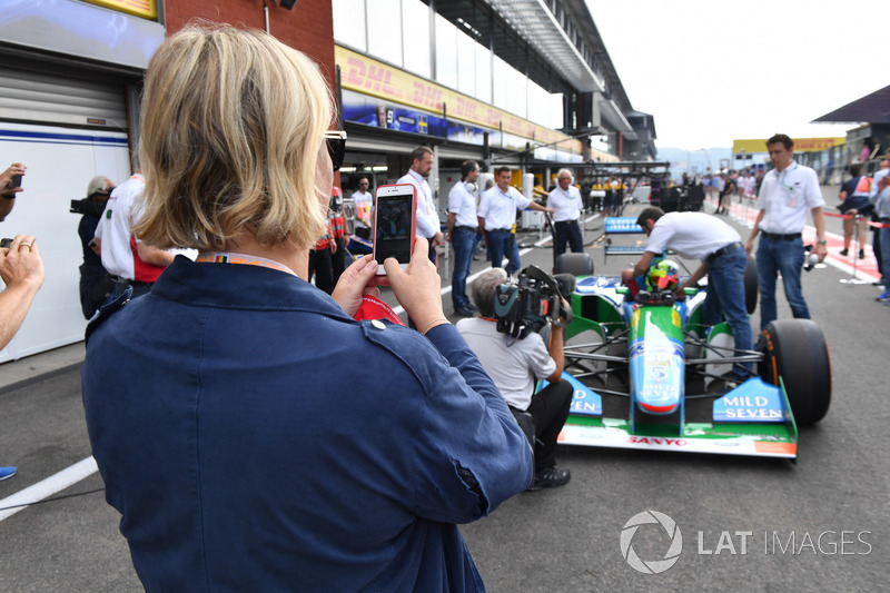 Sabine Kehm, takes a photo of Mick Schumacher, Benetton B194