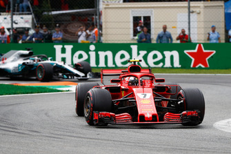 Kimi Raikkonen, Ferrari SF71H, leads Lewis Hamilton, Mercedes AMG F1 W09