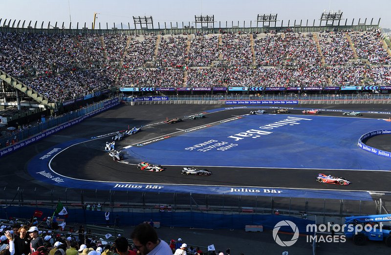 The fans watch the field pass through the stadium section of the track