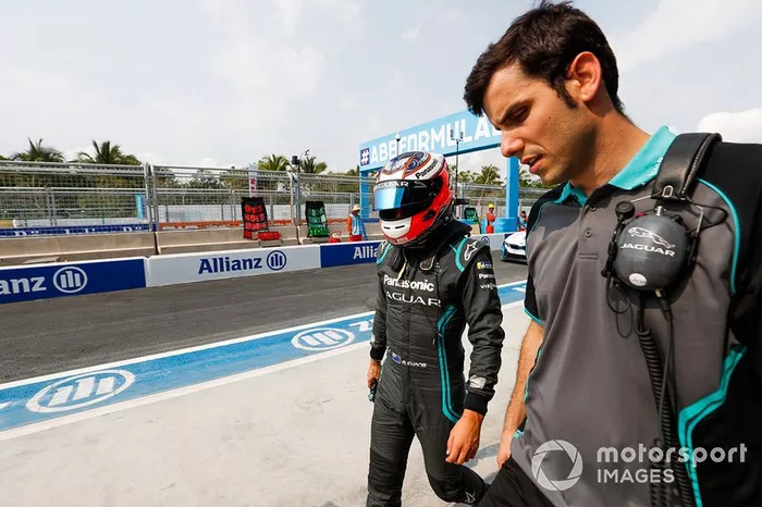 Mitch Evans, Panasonic Jaguar Racing, Jaguar I-Type 3, walks with a team member.