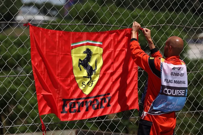 A marshal with a Ferrari flag