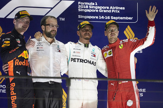 Le deuxième, Max Verstappen, Red Bull Racing, un mécanicien Mercedes, le vainqueur Lewis Hamilton, Mercedes AMG F1, et le troisième, Sebastian Vettel, Ferrari, sur le podium