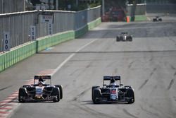 (L to R): Carlos Sainz Jr., Scuderia Toro Rosso STR11 and Fernando Alonso, McLaren MP4-31 battle for