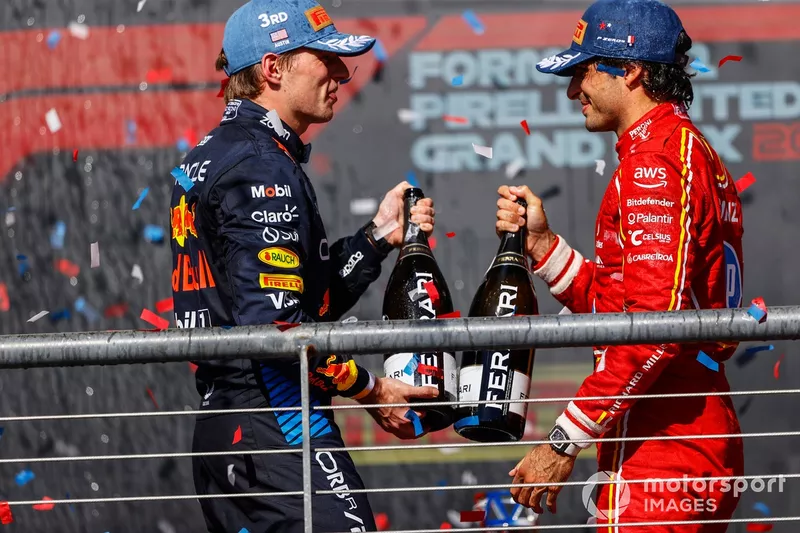 Max Verstappen, Red Bull Racing, 3rd position, Carlos Sainz, Scuderia Ferrari, 2nd position, cheer with their champagne bottles on the podium 