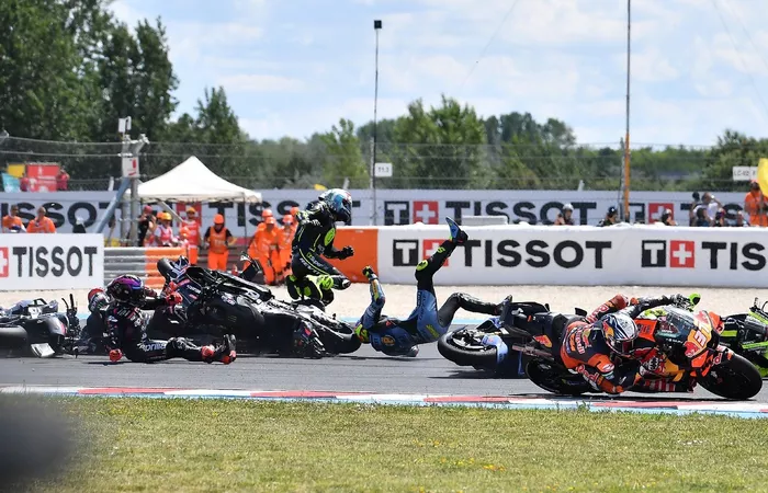 TOPSHOT - Riders collide after the start during the Hungarian Motorcycle MotoGP Grand Prix at the Balaton Park circuit in Balatonfokajar, Hungary, on June 7, 2026. (Photo by Ferenc ISZA / AFP via Getty Images)