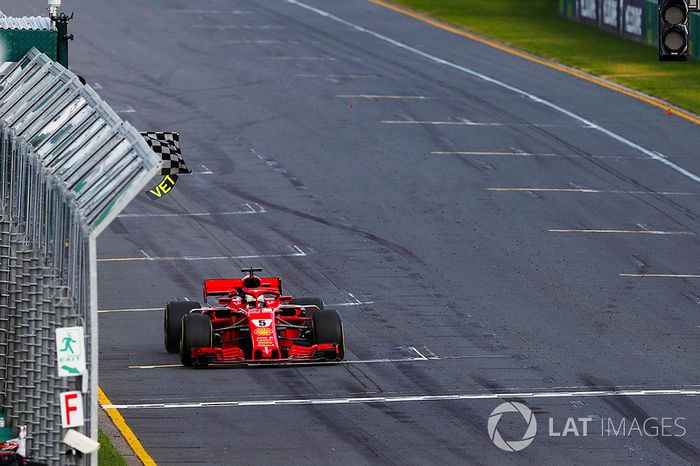 Sebastian Vettel, Ferrari SF71H, takes the chequered flag ahead of Lewis Hamilton, Mercedes AMG F1 W09