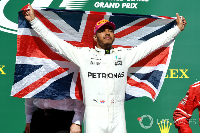 Race winner Lewis Hamilton, Mercedes AMG F1 celebrates on the podium with the Union Jack flag