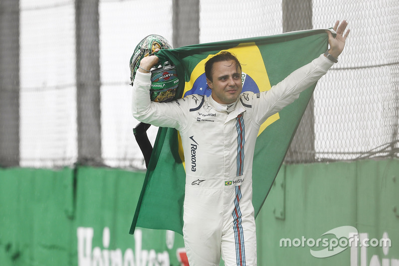 Felipe Massa, Williams, carries a Brazilian flag as he walks back to his garage in tears after crash