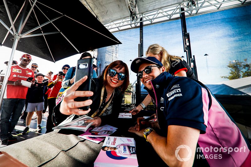 Sergio Perez, Racing Point poses for a selfie with a fan