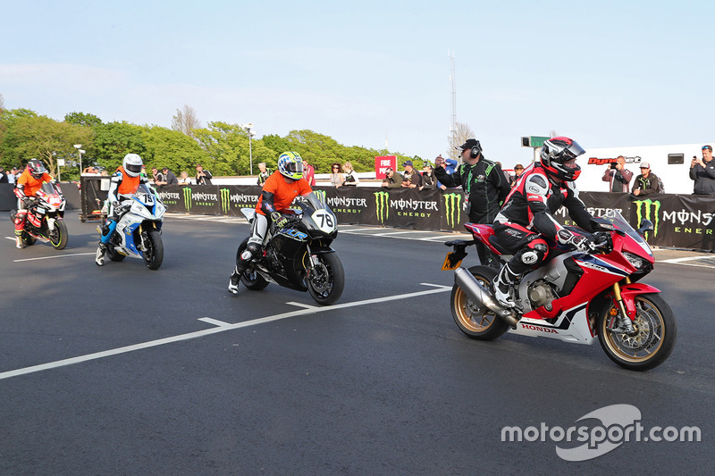 Isle of Man TT Rider Liaison officer Richard Milky Quayle gets proceedings underway by taking the Newcomers on their speed-controlled lap of the Mountain Course