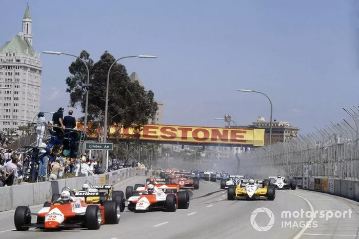 Andrea de Cesaris, Alfa Romeo 182 leads Niki Lauda, McLaren MP4/1B-Ford Cosworth, Rene Arnoux, Renault RE30B, Alain Prost, Renault RE30B, Bruno Giacomelli, Alfa Romeo 182, Gilles Villeneuve, Ferrari 126C2, Nelson Piquet, Brabham BT49D-Ford Cosworth and Keke Rosberg, Williams FW07C-Ford Cosworth, at the start
