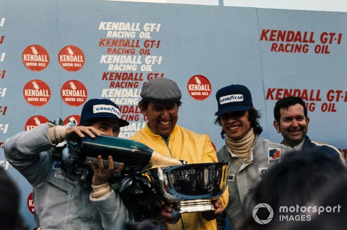 Podium: Ken Tyrrell celebrates with his drivers Race winner Jackie Stewart and François Cevert, Tyrrell